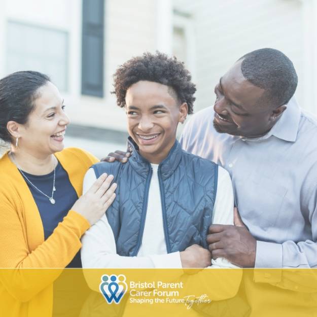 Two adults smiling and standing close with a teenage boy, showing support and encouragement in a bright indoor setting