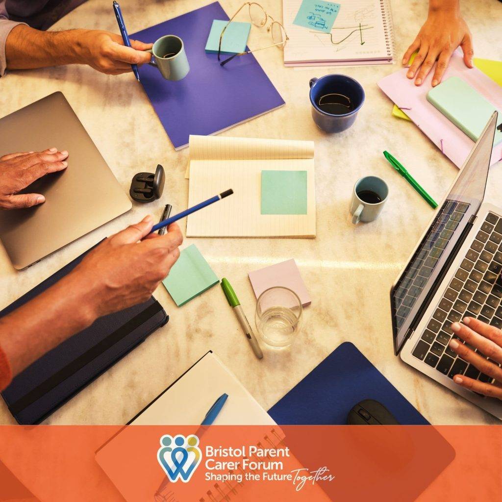People working together around a table with laptops, notebooks and coffee, representing collaboration by Bristol Parent Carer Forum