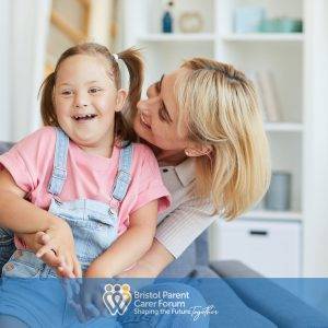 Woman holding young girl with SEND